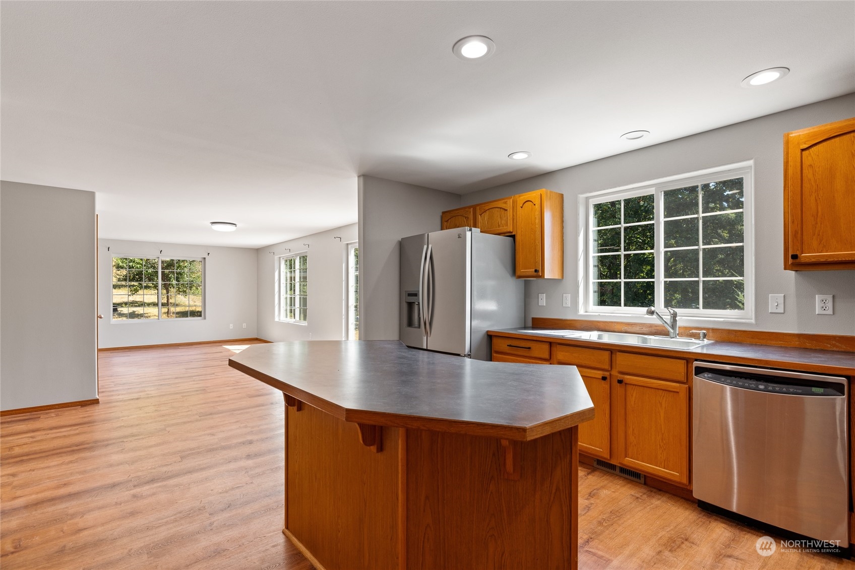 257 Buckhorn Road Winlock, WA 98596 - Photo 9 of 38 a kitchen with stainless steel appliances granite countertop a sink a window and wooden floor