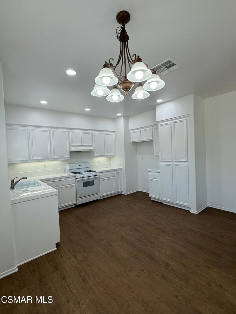1719 Watercrest Way Simi Valley, CA 93065 - Photo 3 of 26 a view of a kitchen with a sink dishwasher a refrigerator freezer and a dishwasher
