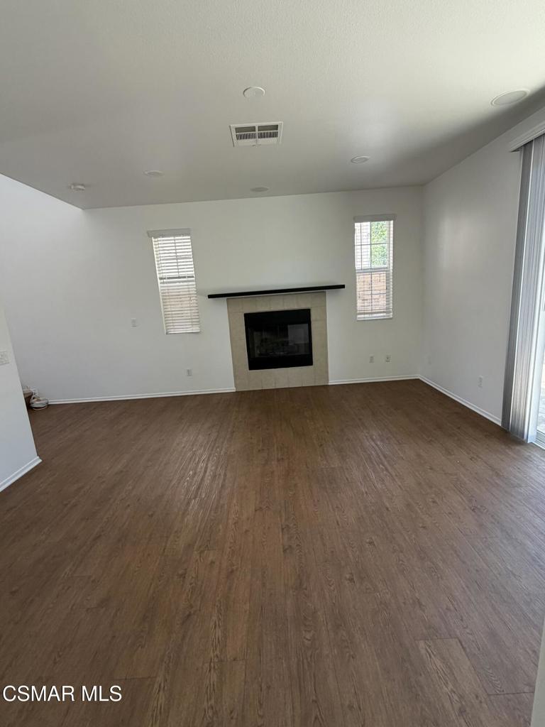 1719 Watercrest Way Simi Valley, CA 93065 - Photo 7 of 26 an empty room with wooden floor fireplace and windows