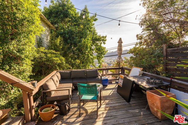 a view of a balcony with chairs and wooden floor
