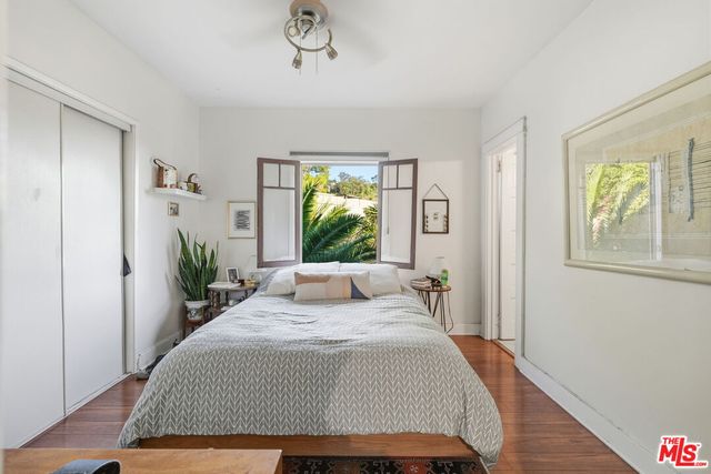 a bed sitting in a bedroom next to a window