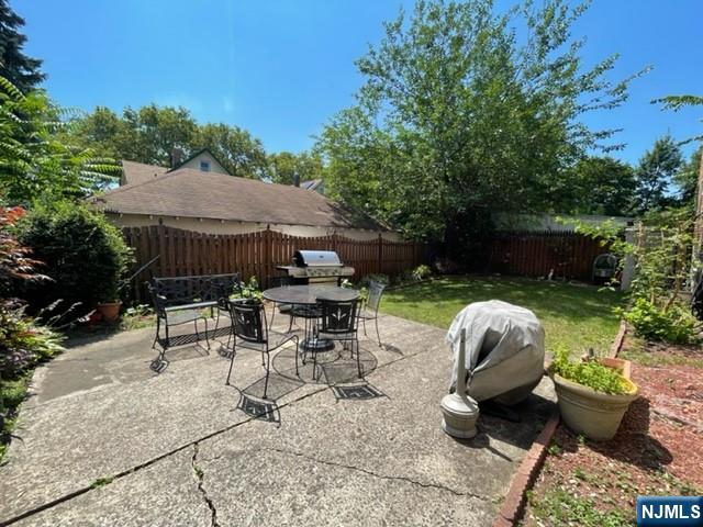 215 Orient Way, Unit C2 Rutherford, NJ 07070 - Photo 25 of 25 a view of a patio with table and chairs potted plants and a palm tree