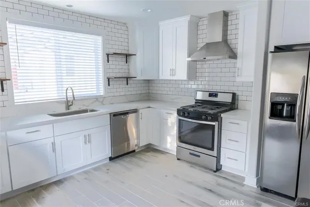a kitchen with a sink stove and cabinets