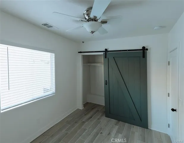 a view of entryway with window and wooden floor