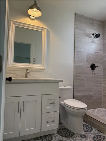 a bathroom with a toilet sink and shower