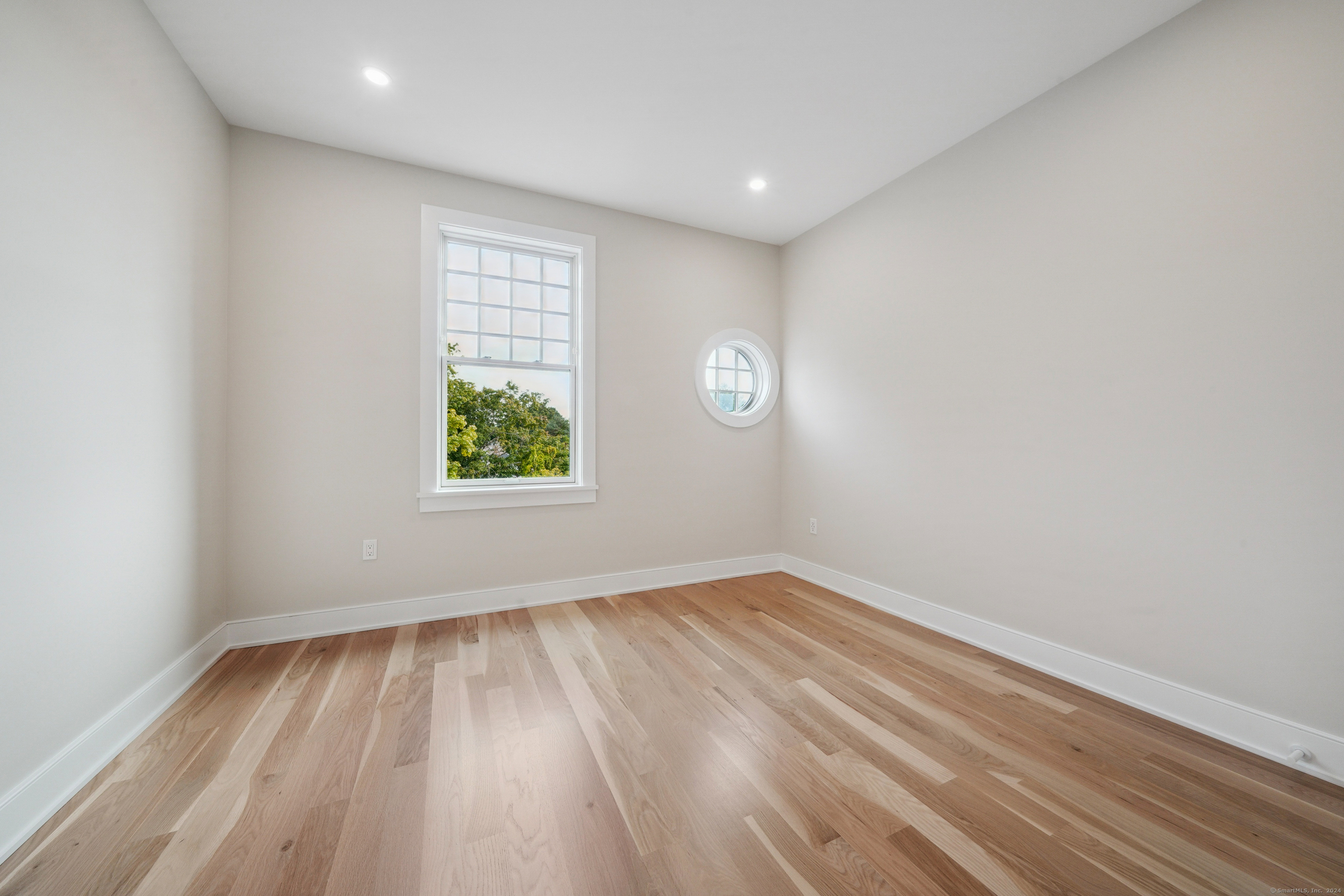 8 Husted Lane, Unit 2D New Canaan, CT 06840 - Photo 12 of 18 wooden floor in an empty room with a window