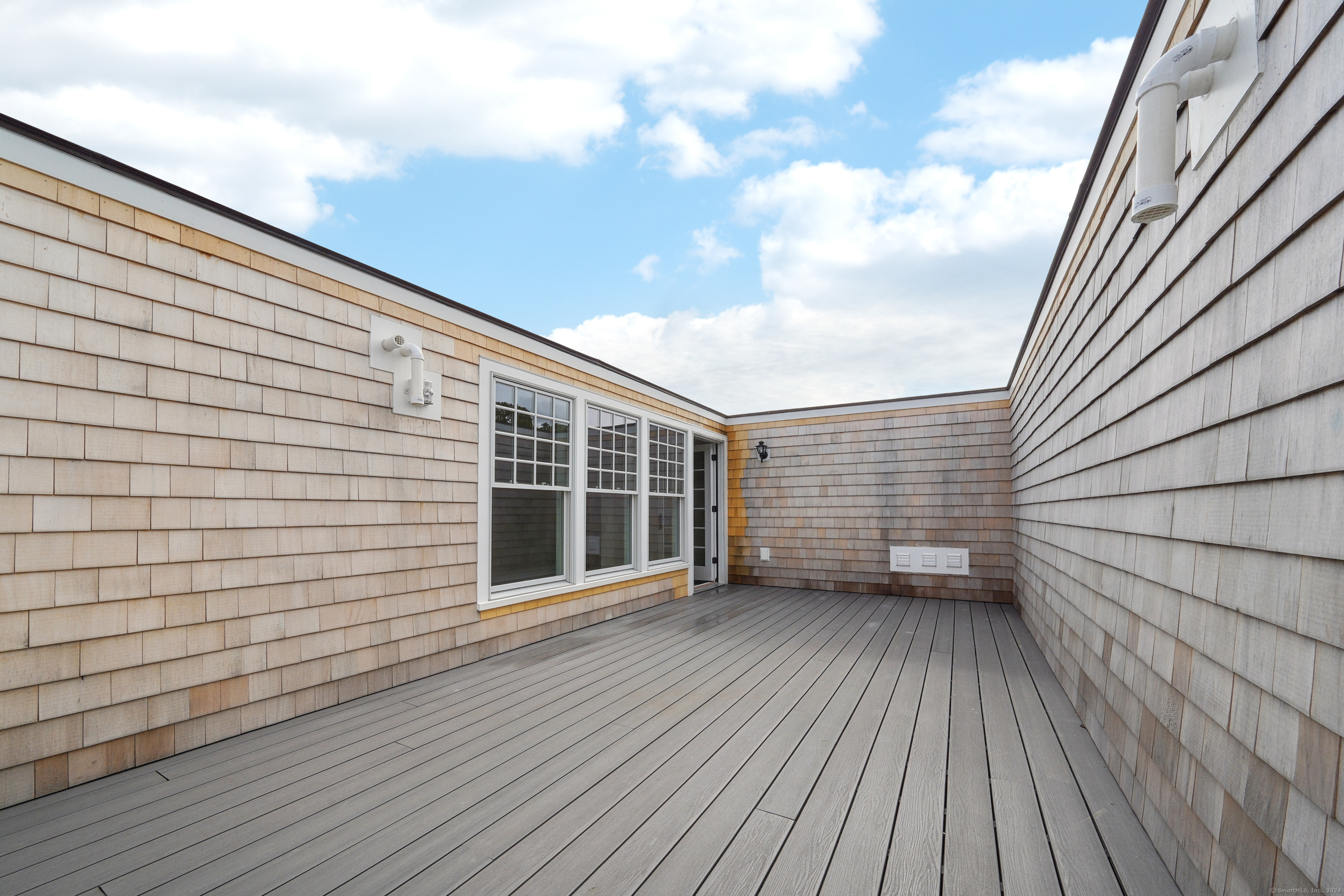 8 Husted Lane, Unit 2D New Canaan, CT 06840 - Photo 18 of 18 a view of an empty room with wooden floor and a window