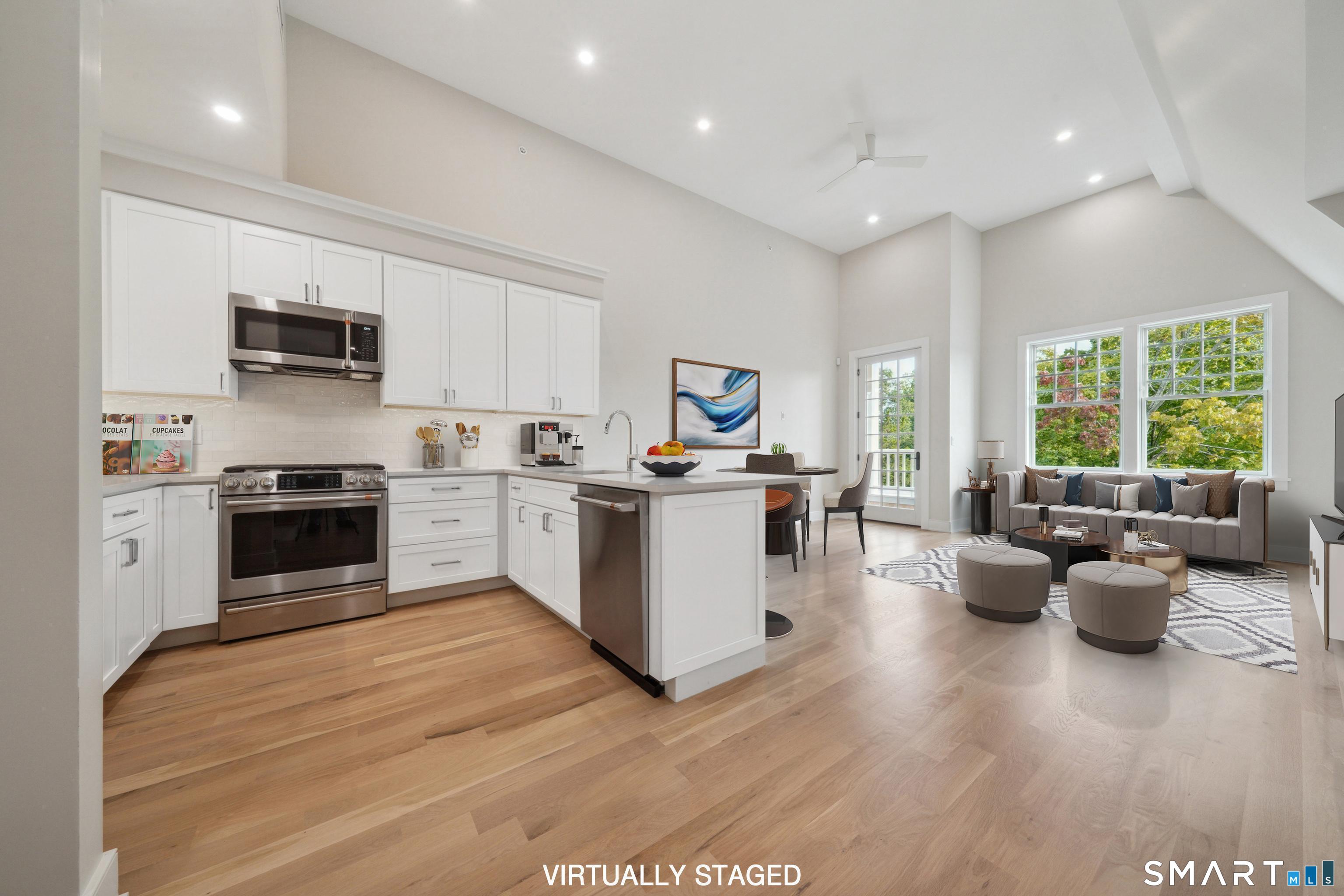 8 Husted Lane, Unit 2D New Canaan, CT 06840 - Photo 2 of 18 a kitchen with a stove a sink dishwasher a refrigerator and a dining table with wooden floor