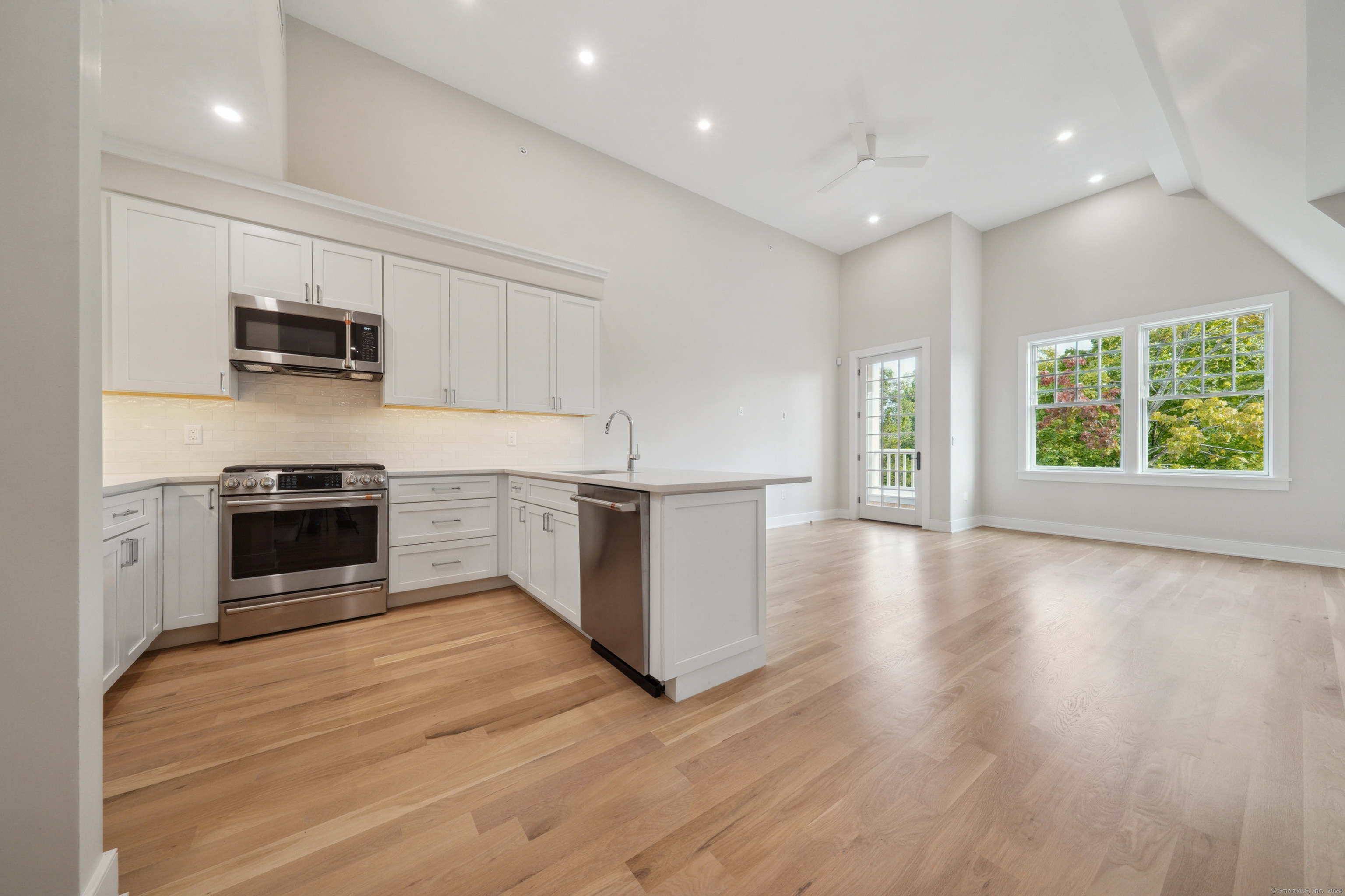 8 Husted Lane, Unit 2D New Canaan, CT 06840 - Photo 3 of 18 a kitchen with stainless steel appliances a stove top oven a sink and a microwave