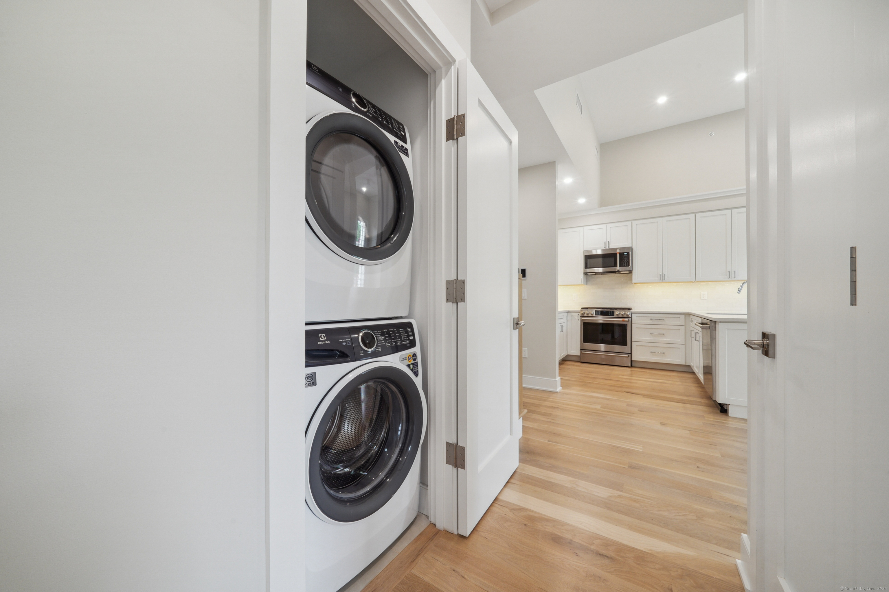 8 Husted Lane, Unit 2D New Canaan, CT 06840 - Photo 7 of 18 a view of a kitchen with washer and dryer