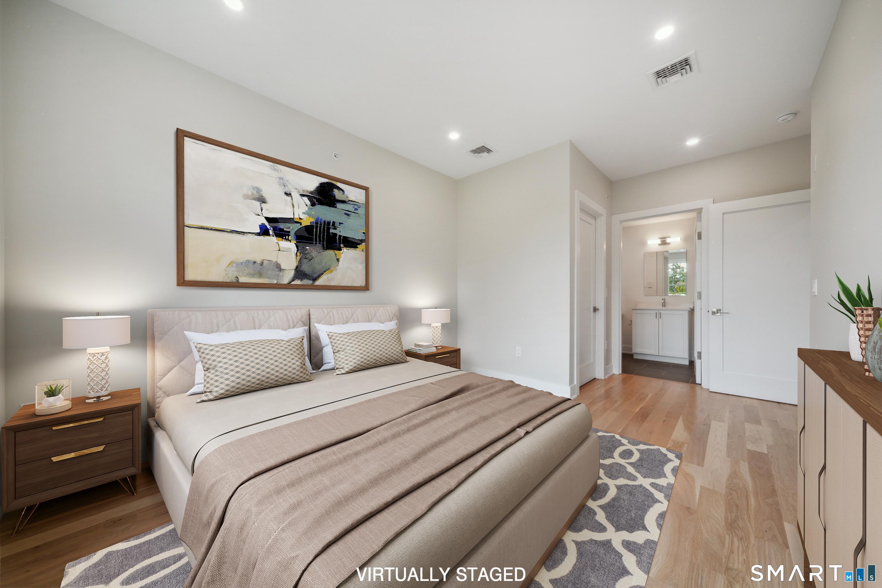 8 Husted Lane, Unit 2D New Canaan, CT 06840 - Photo 8 of 18 a bedroom with a bed and a painting on the wall