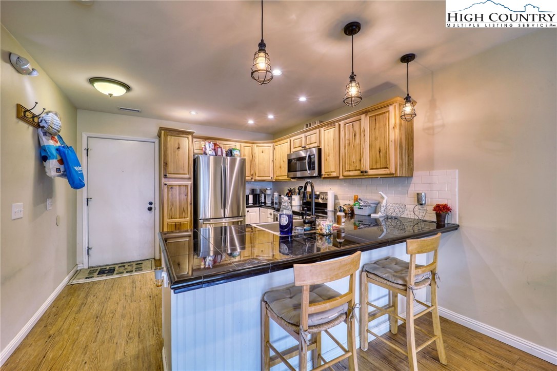 128 Zeb Street, Unit A304 Boone, NC 28607 - Photo 1 of 27 a kitchen with sink refrigerator and cabinets