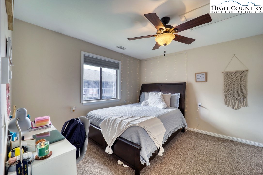 128 Zeb Street, Unit A304 Boone, NC 28607 - Photo 12 of 27 a bedroom with a bed and a ceiling fan