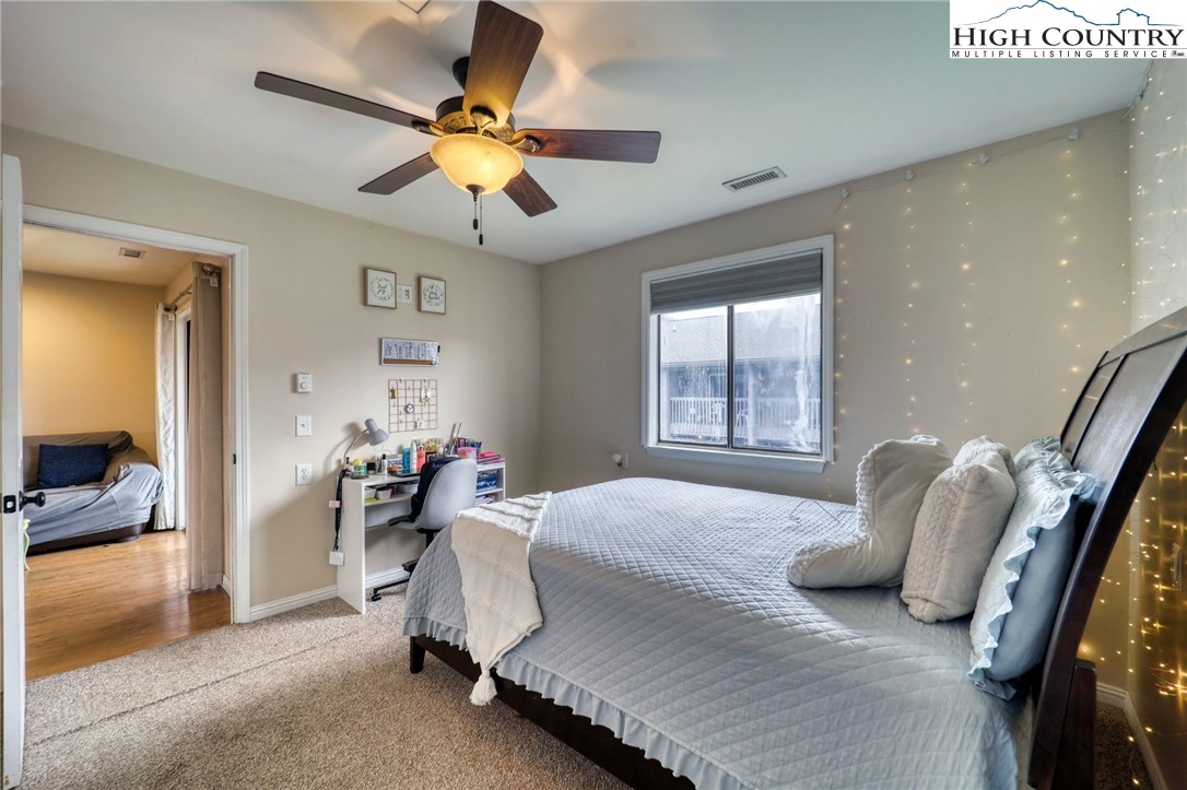 128 Zeb Street, Unit A304 Boone, NC 28607 - Photo 13 of 27 a bedroom with a bed and a chandelier