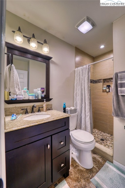 128 Zeb Street, Unit A304 Boone, NC 28607 - Photo 14 of 27 a bathroom with a toilet sink double vanity and mirror