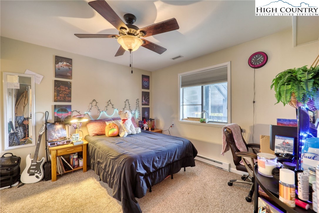 128 Zeb Street, Unit A304 Boone, NC 28607 - Photo 16 of 27 a bedroom with a bed and a chandelier