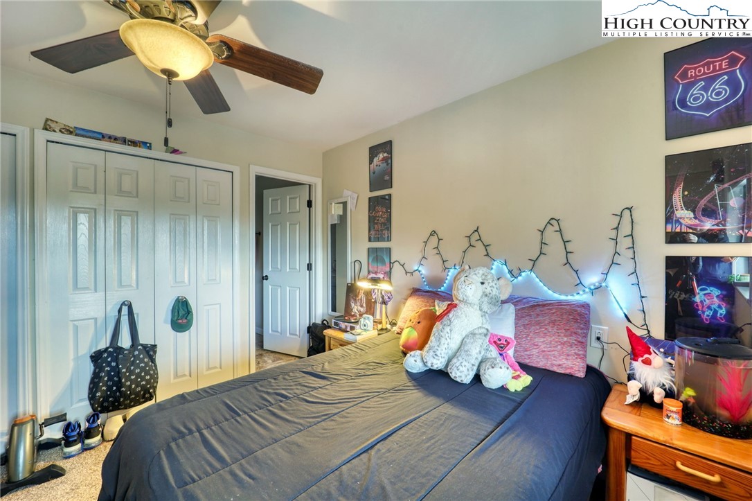 128 Zeb Street, Unit A304 Boone, NC 28607 - Photo 17 of 27 a bedroom with bed and a chandelier