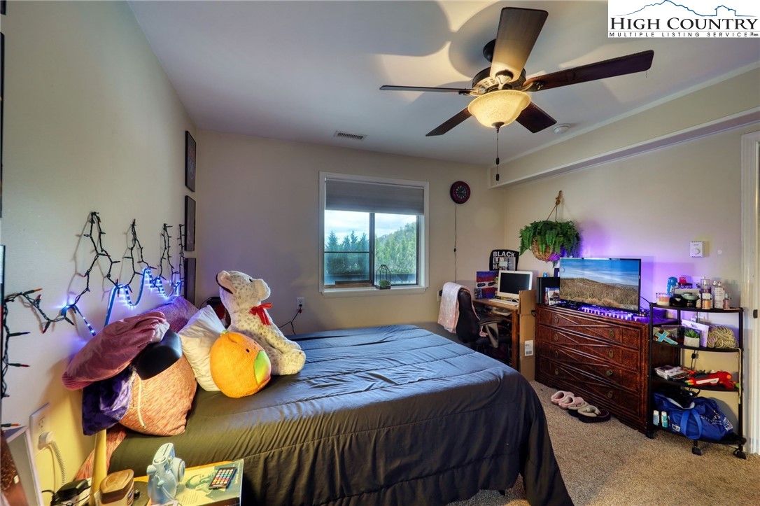 128 Zeb Street, Unit A304 Boone, NC 28607 - Photo 18 of 27 a bedroom with a bed and wooden floor