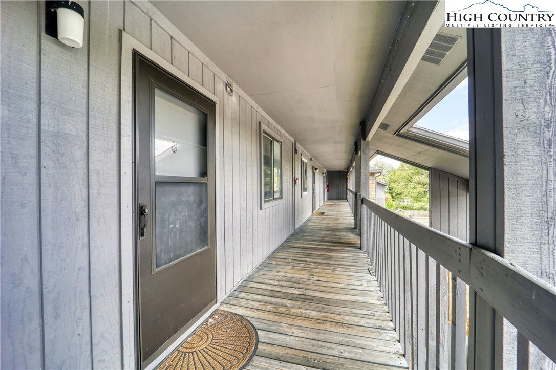 128 Zeb Street, Unit A304 Boone, NC 28607 - Photo 2 of 27 a view of a hallway with wooden floor and staircase