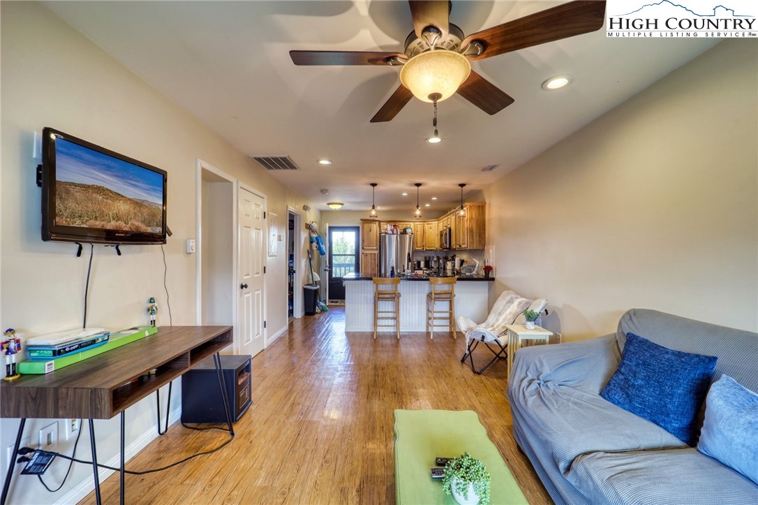 128 Zeb Street, Unit A304 Boone, NC 28607 - Photo 4 of 27 a living room with furniture and a flat screen tv