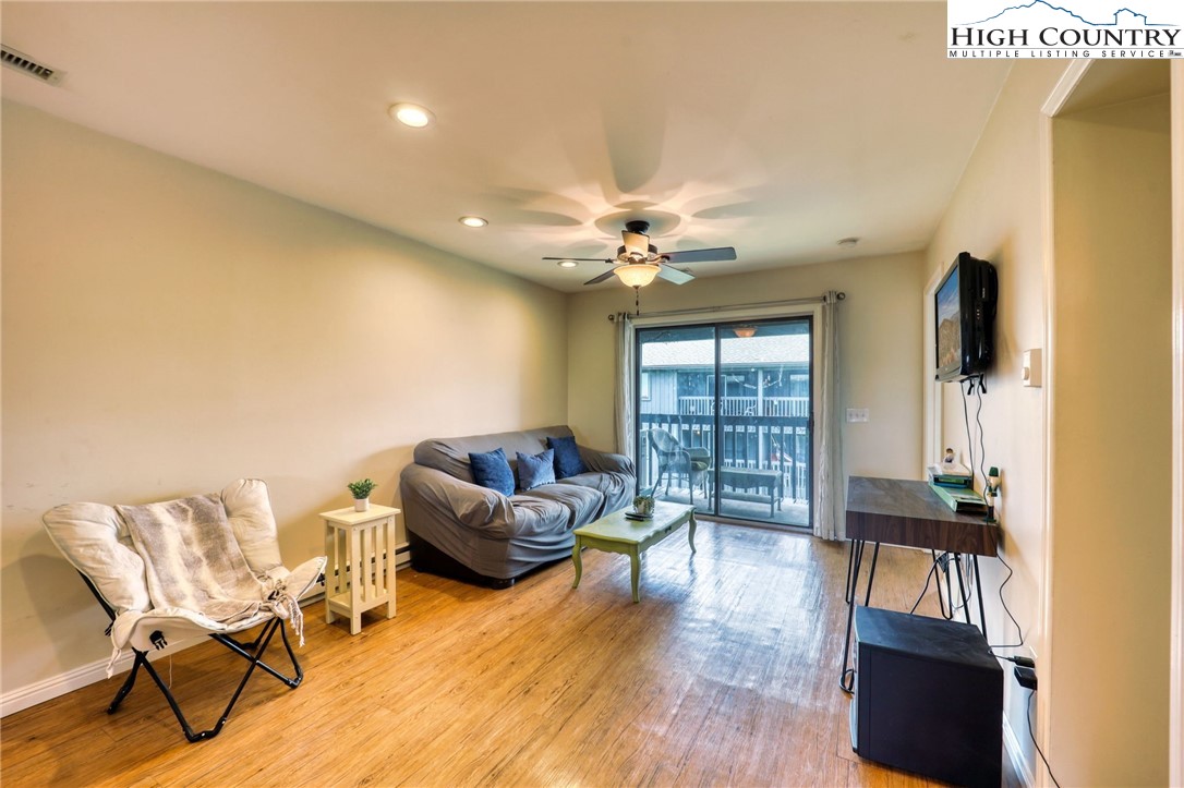 128 Zeb Street, Unit A304 Boone, NC 28607 - Photo 6 of 27 a living room with furniture and a flat screen tv