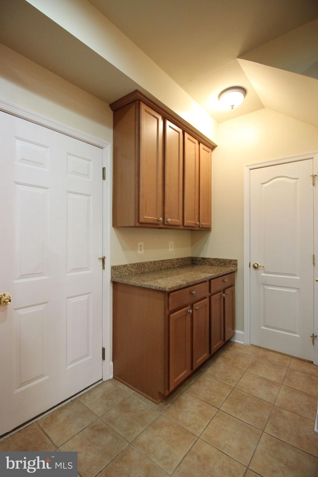 13608 Dover Cliffs Place Germantown, MD 20874 - Photo 10 of 32 a kitchen with stainless steel appliances granite countertop a sink and a granite counter tops