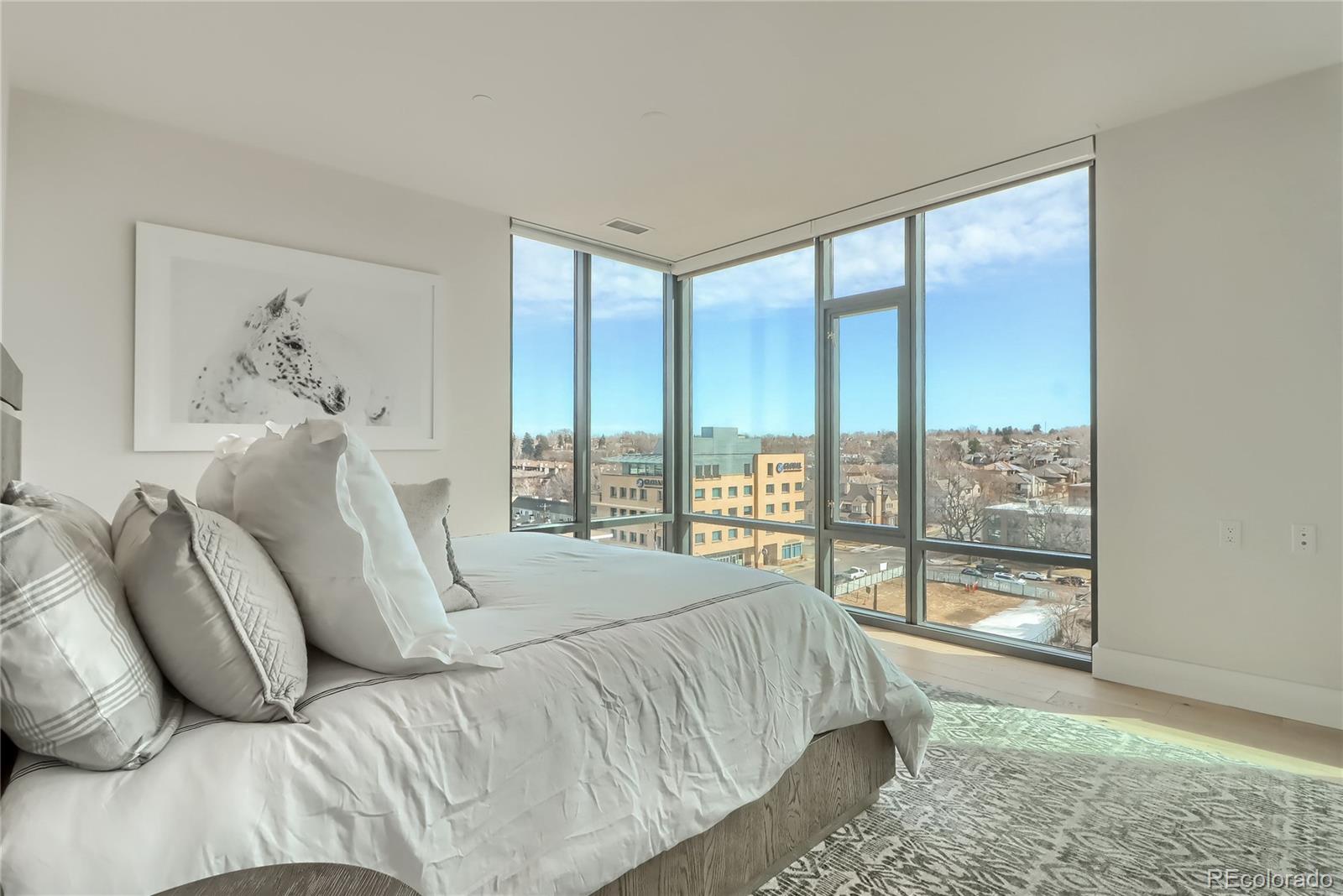 155 Steele Street, Unit 814 Denver, CO 80206 - Photo 13 of 39 a bedroom with a large bed and a window