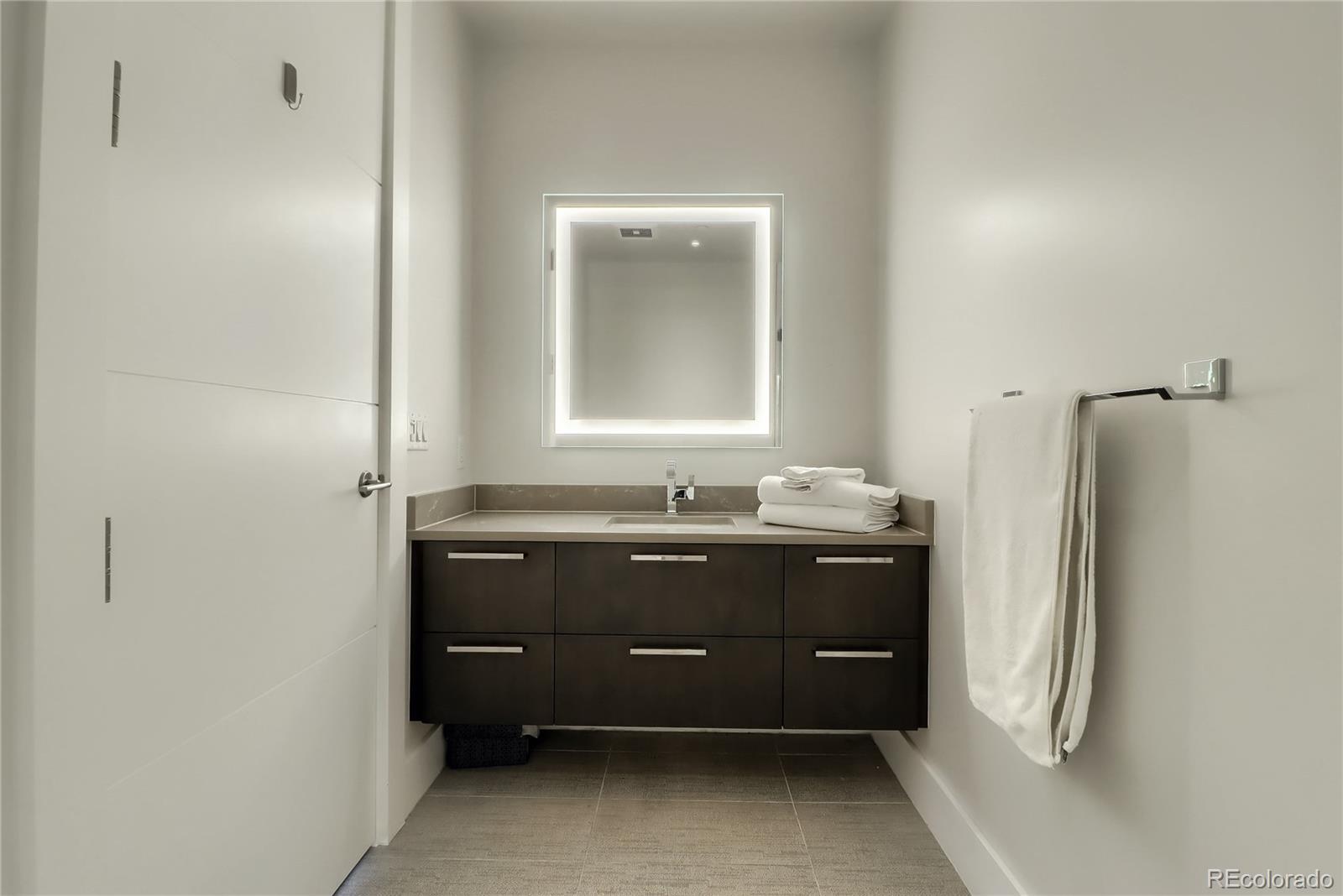 155 Steele Street, Unit 814 Denver, CO 80206 - Photo 20 of 39 a room with a sink and a mirror