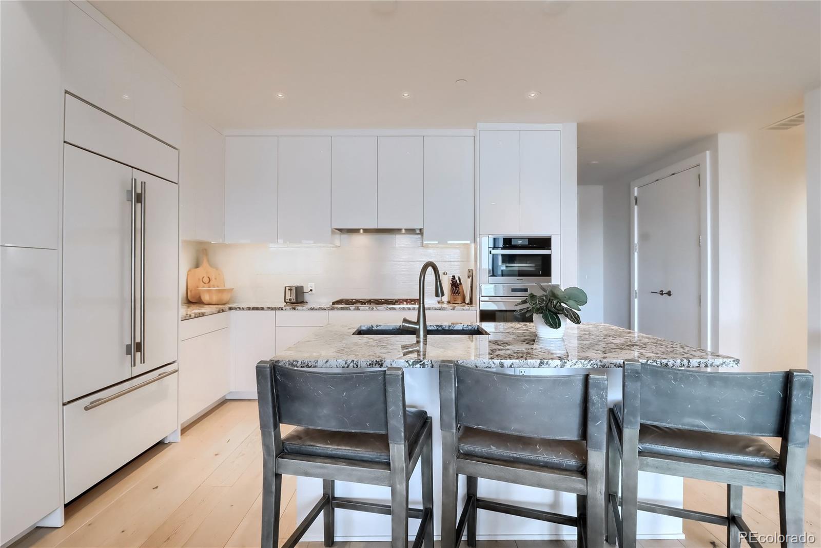 155 Steele Street, Unit 814 Denver, CO 80206 - Photo 10 of 39 a kitchen with a dining table chairs and refrigerator