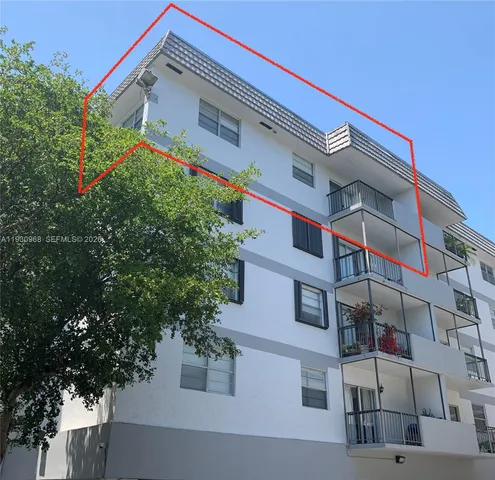 a front view of a house with a tree
