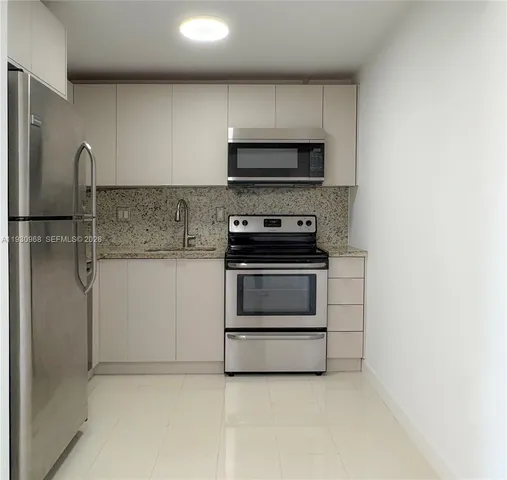 a kitchen with a stove and a refrigerator