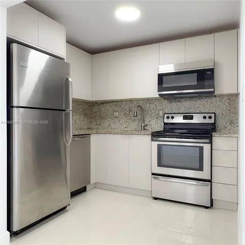 a kitchen with a refrigerator sink and microwave