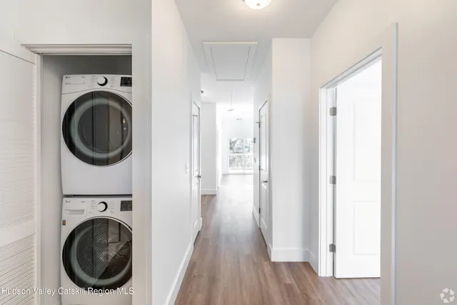 a view of a hallway with washer and dryer