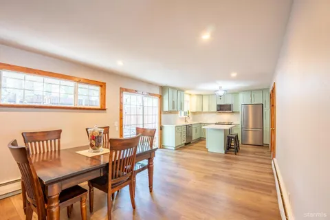 a view of a dining room with furniture and a window