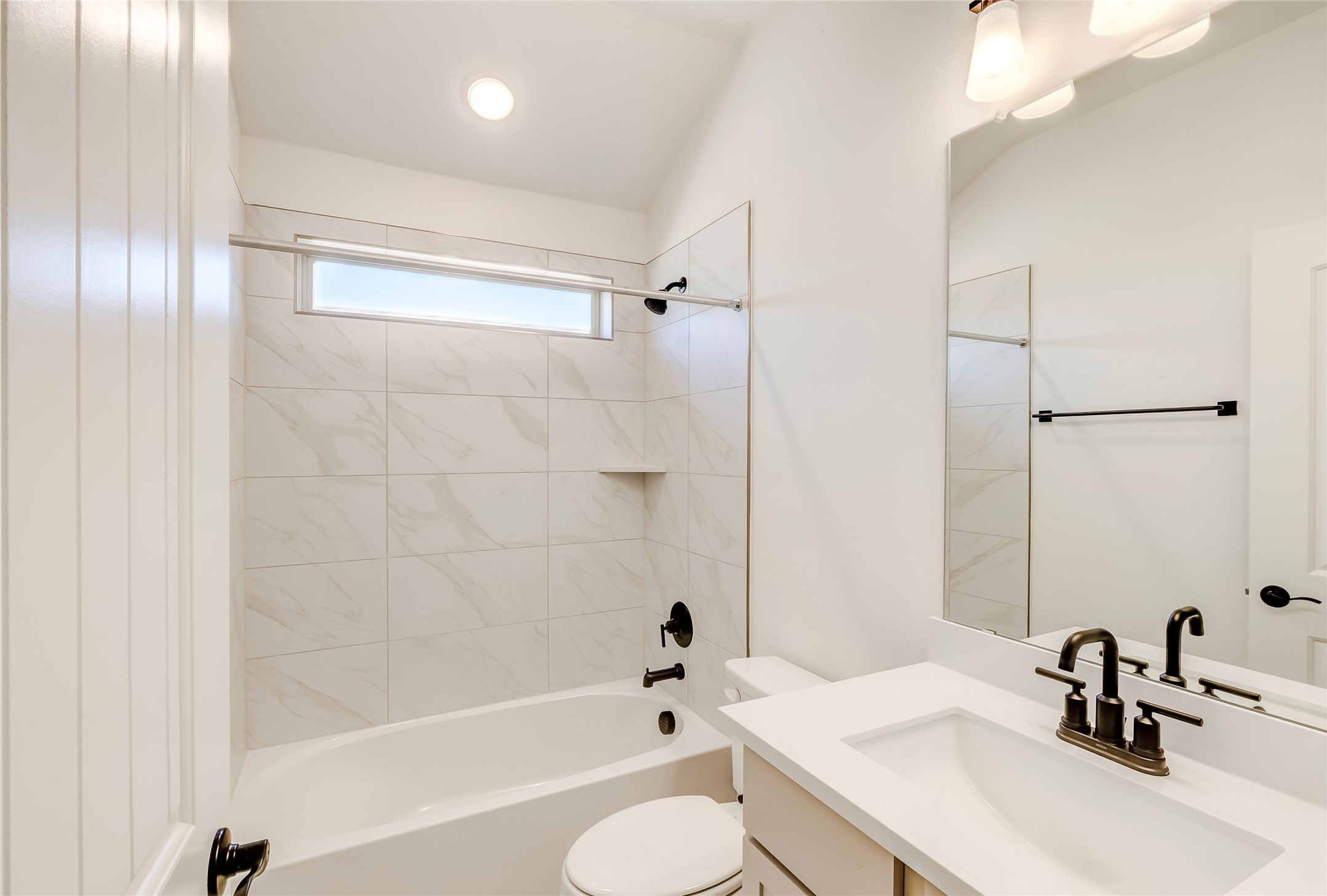 920 Old Gdn Road Leander, TX 78641 - Photo 28 of 39 Bathroom featuring shower combination, vanity, and lofted ceiling