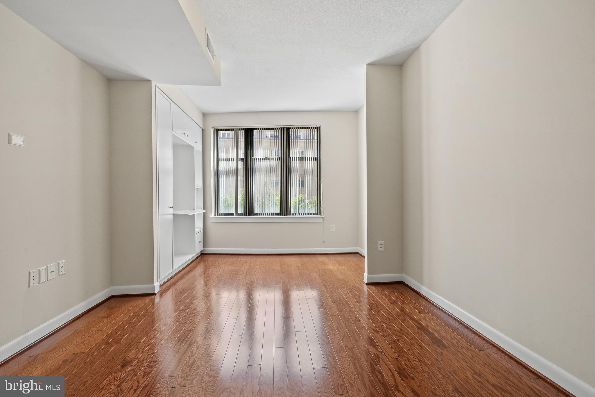 400 Massachusetts Avenue Northwest, Unit 421 Washington, DC 20001 - Photo 17 of 48 wooden floor in an empty room with a window