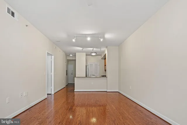 a kitchen with stainless steel appliances a sink a stove cabinets and a window