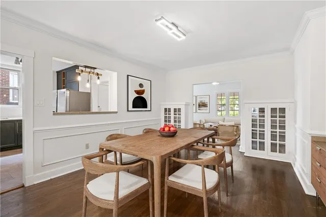 a dining room with furniture and wooden floor