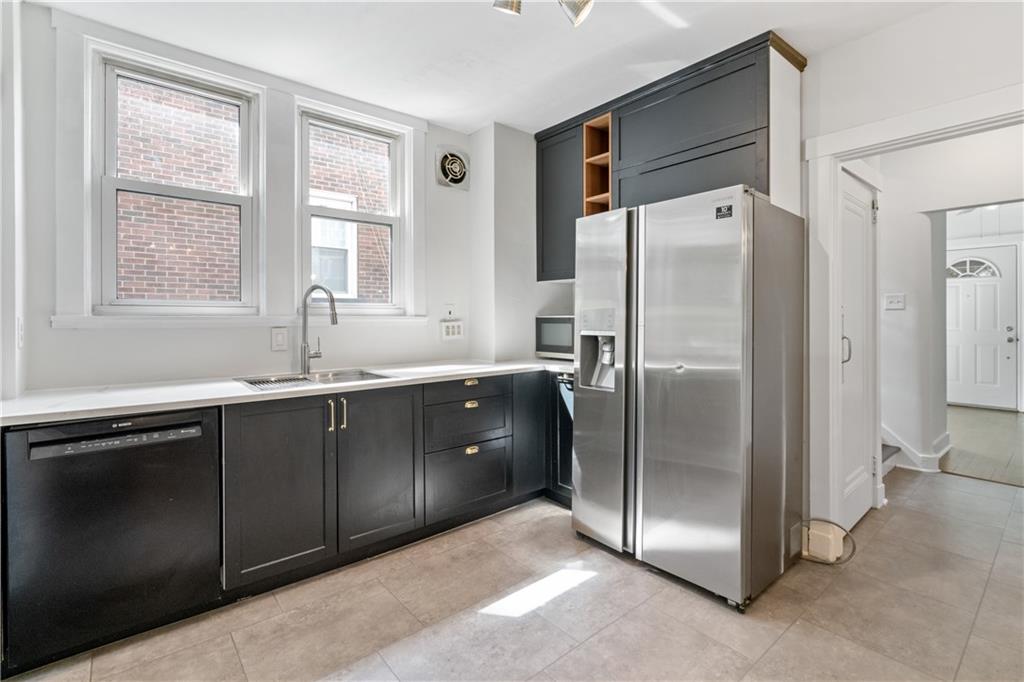 6418 Landview Road Pittsburgh, PA 15217 - Photo 18 of 45 a kitchen with stainless steel appliances granite countertop a refrigerator and a sink