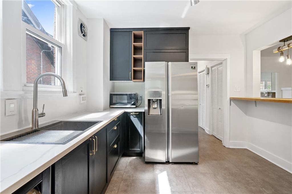 6418 Landview Road Pittsburgh, PA 15217 - Photo 19 of 45 a kitchen with stainless steel appliances granite countertop a refrigerator a sink and a stove