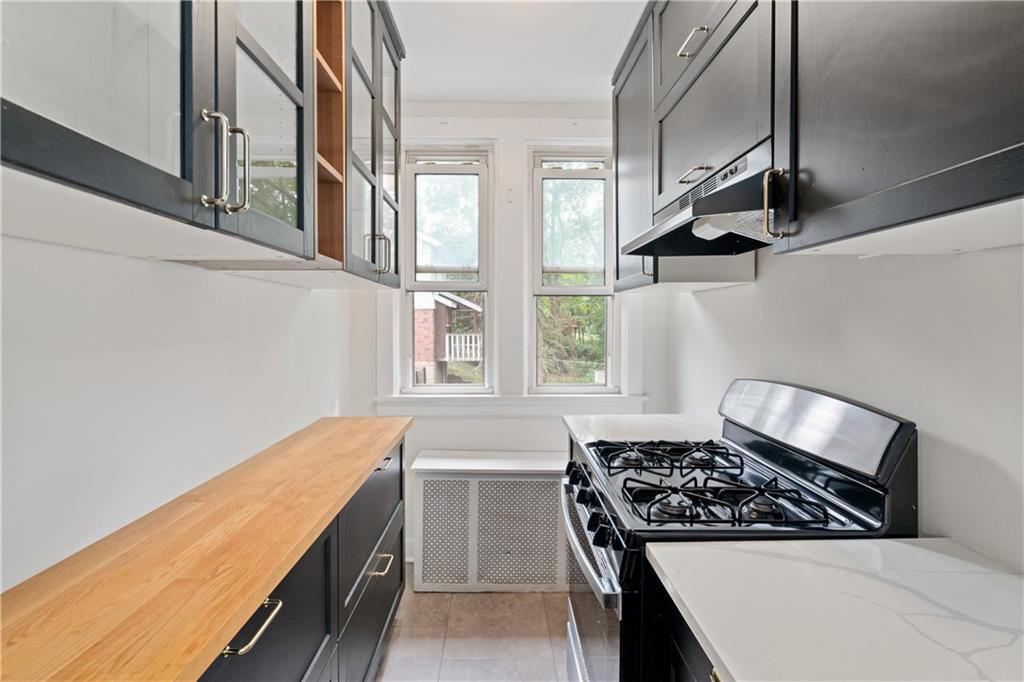 6418 Landview Road Pittsburgh, PA 15217 - Photo 21 of 45 a kitchen with stainless steel appliances a stove and a refrigerator