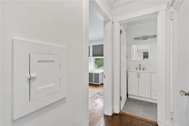 a view of a hallway with wooden floor