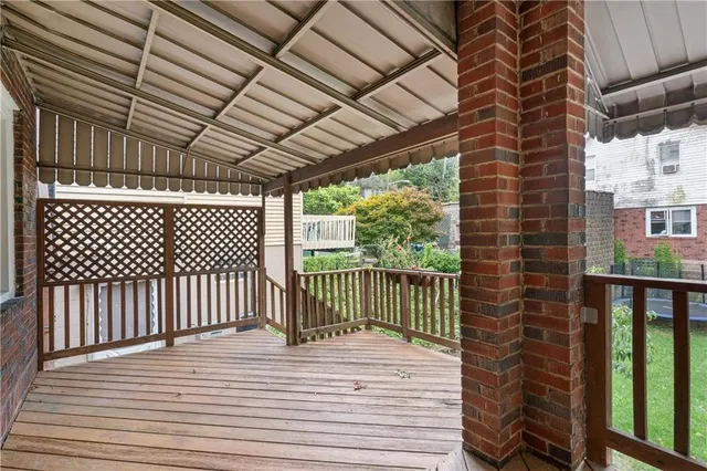 a view of a balcony with wooden floor
