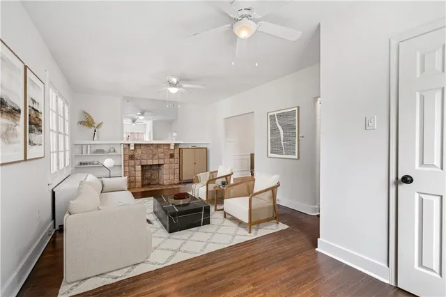 a living room with furniture a fireplace and wooden floor