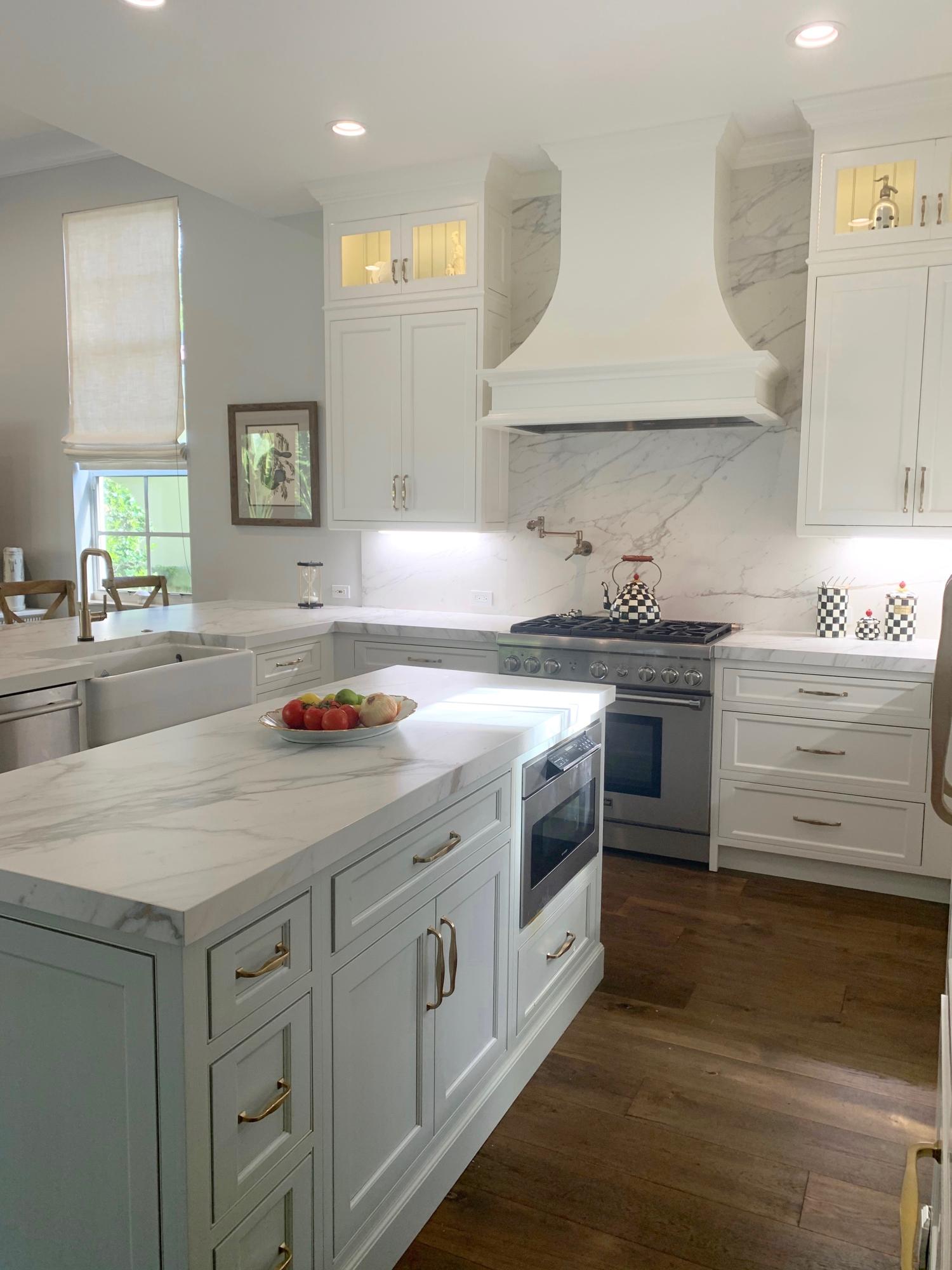 108 Santander Drive Jupiter, FL 33458 - Photo 2 of 19 a kitchen with granite countertop a sink a stove and cabinets