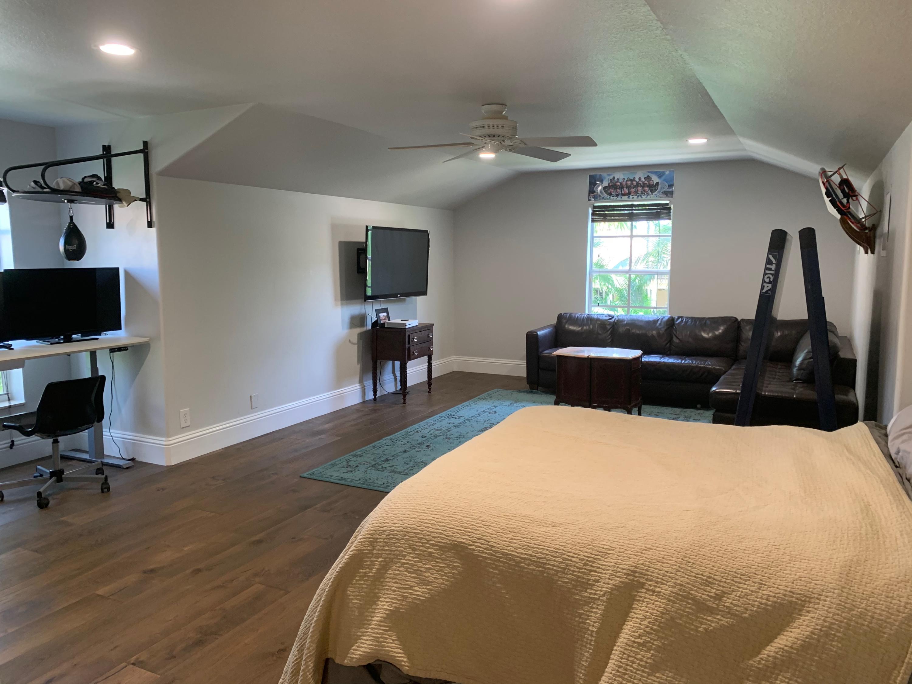 108 Santander Drive Jupiter, FL 33458 - Photo 14 of 19 a bed room with a bed window and a chair