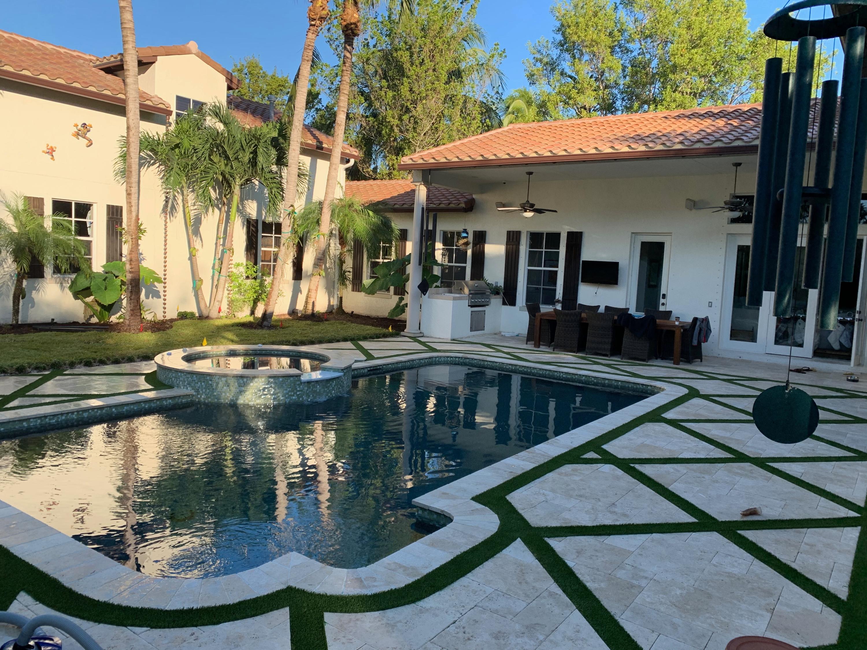 108 Santander Drive Jupiter, FL 33458 - Photo 15 of 19 a view of a house with swimming pool and sitting area
