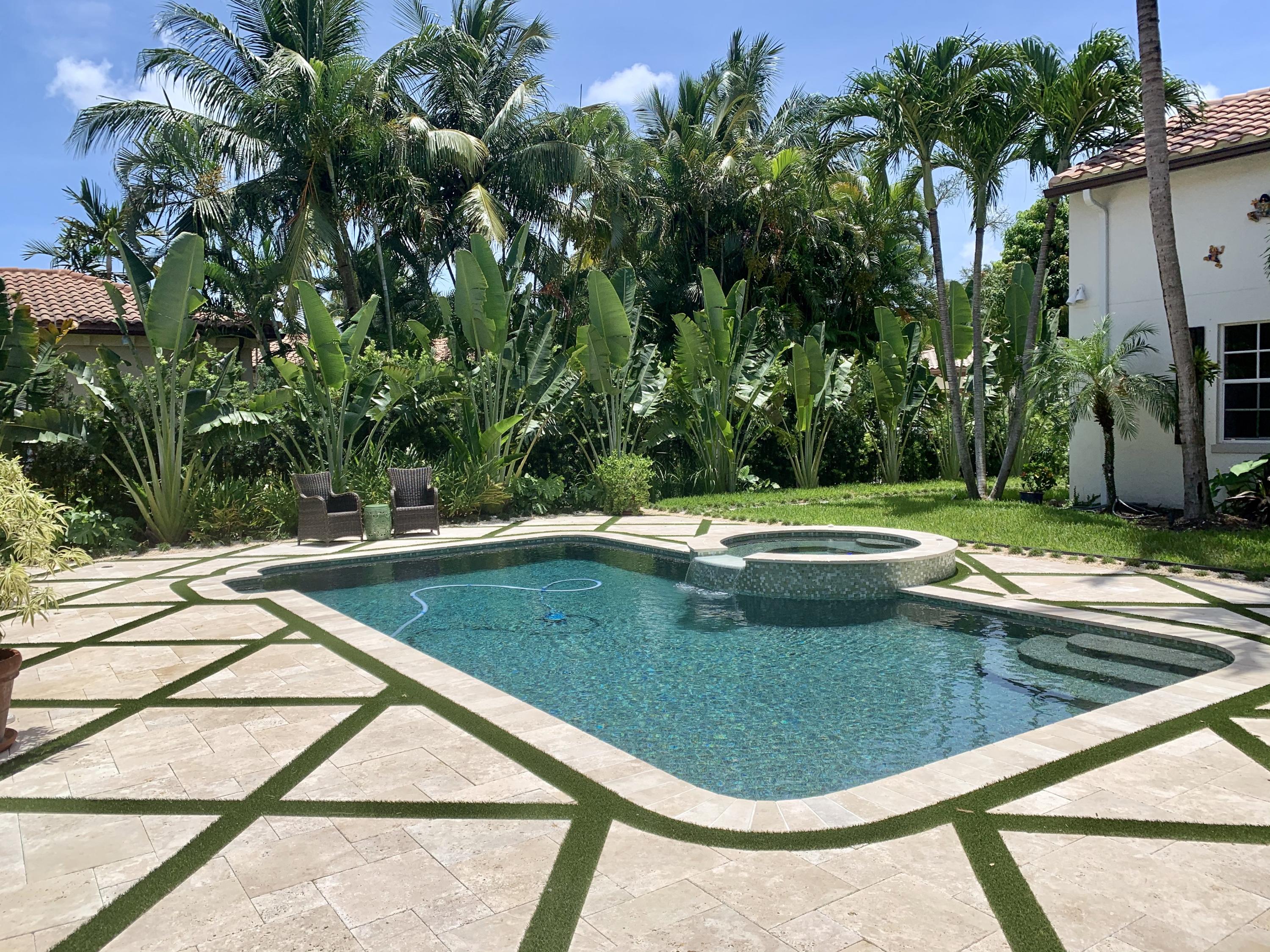108 Santander Drive Jupiter, FL 33458 - Photo 16 of 19 a view of a swimming pool with a yard and sitting space
