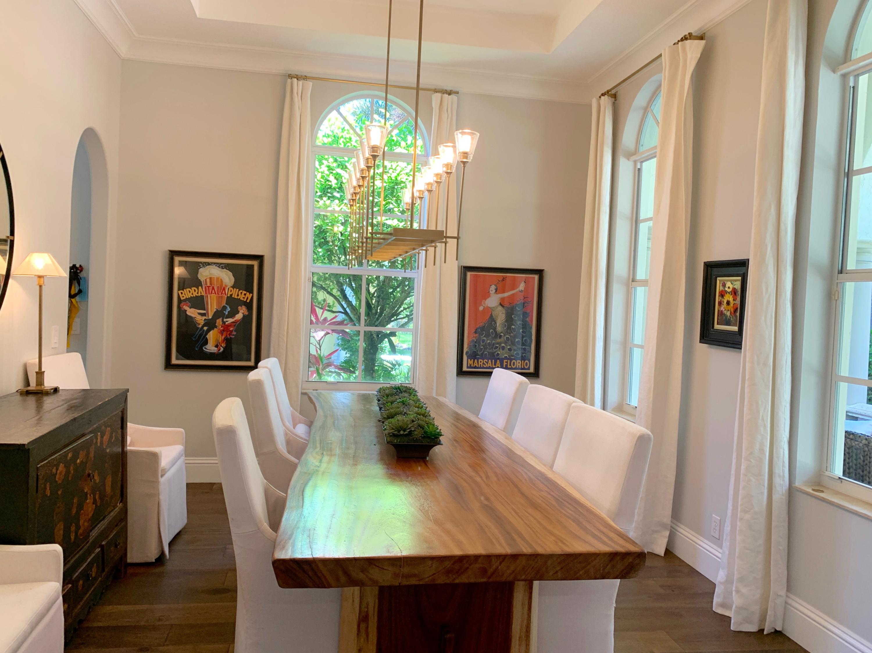 108 Santander Drive Jupiter, FL 33458 - Photo 8 of 19 a view of a dining room with furniture and a chandelier