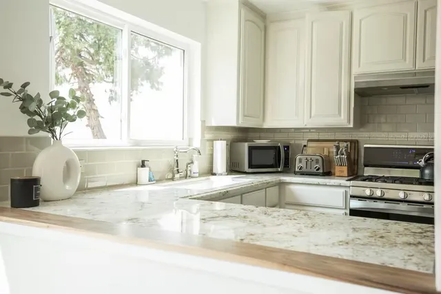 a kitchen with stainless steel appliances granite countertop a sink and a granite counter tops